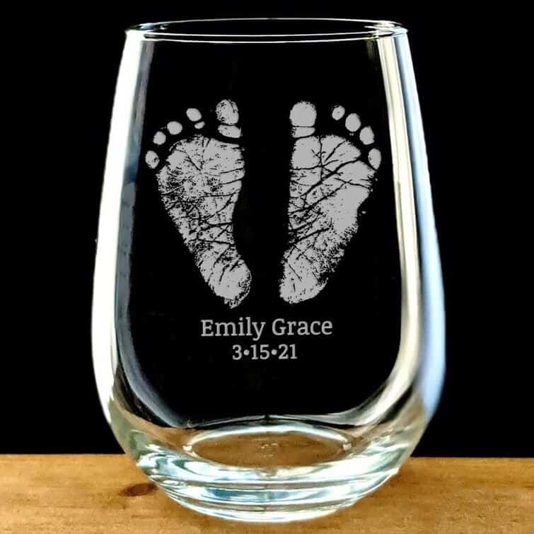 a beer glass with baby footprint