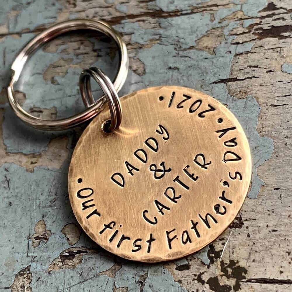 a personalized keychain with dad and baby's names