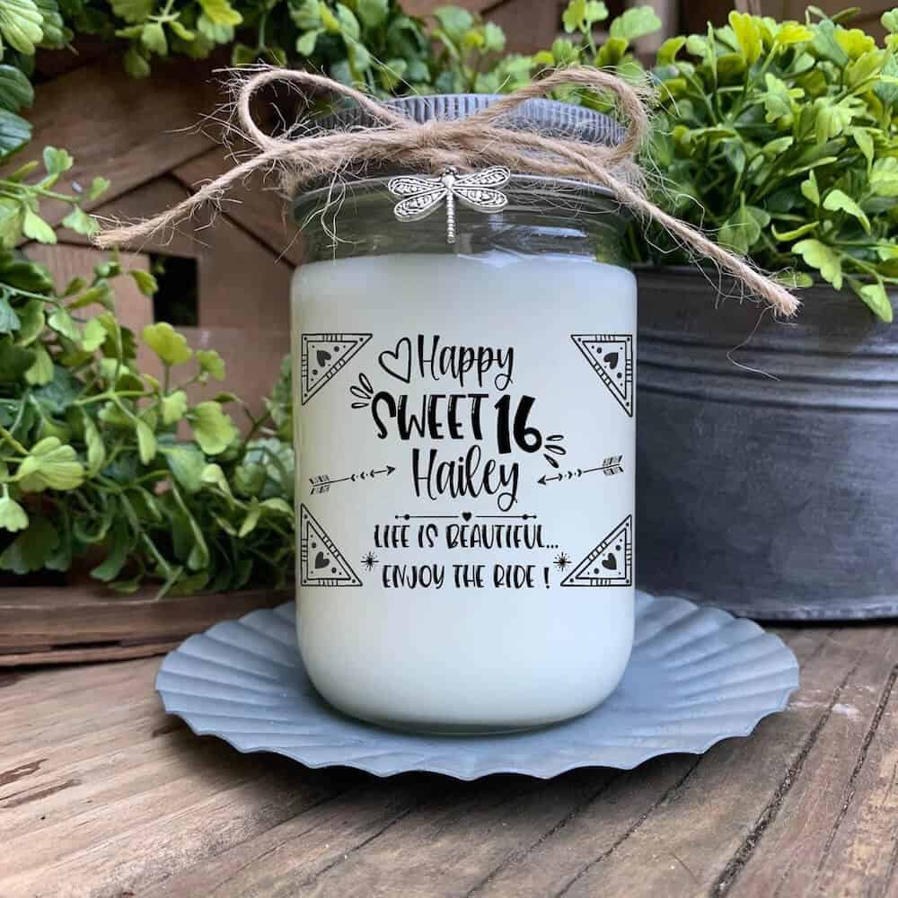 a scented candle that says happy sweet 16